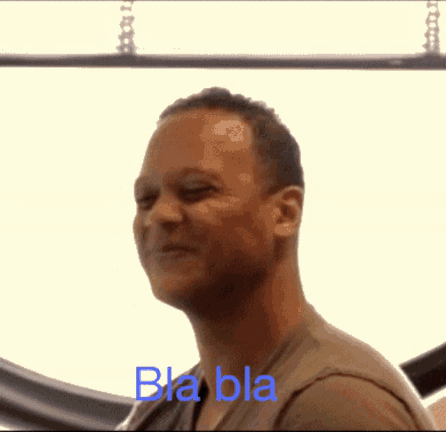 a blurry image of a person 's face with the words bla bla written in blue