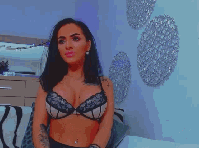 a woman in a bra with a tattoo on her chest