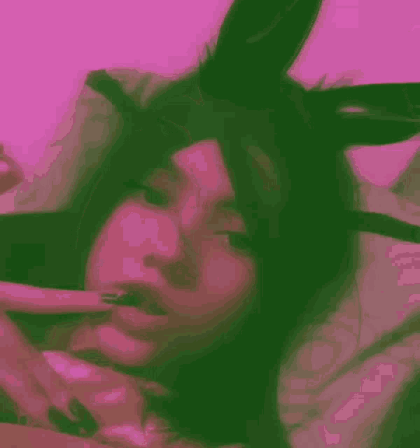 a woman wearing bunny ears is laying in bed .