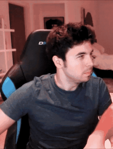 a man is sitting in a chair with the letter d on the back of it