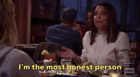 a woman is sitting at a table talking to another woman and says i 'm the most honest person .