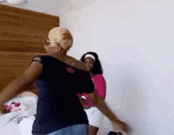 a group of women are dancing in a room .