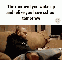 a man is sitting on a couch with his feet up and says `` the moment you wake up and realize you have school tomorrow ''