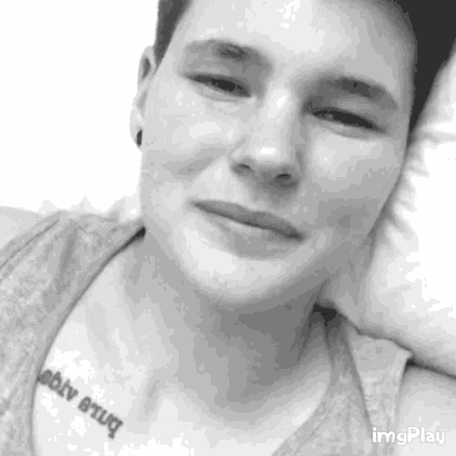 a black and white photo of a person with a tattoo on their chest that says ' ability brug '