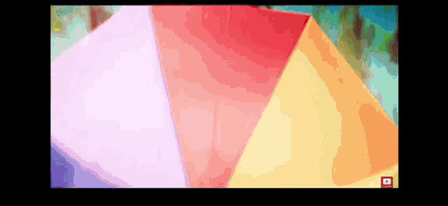 a colorful background with a red square in the upper right corner
