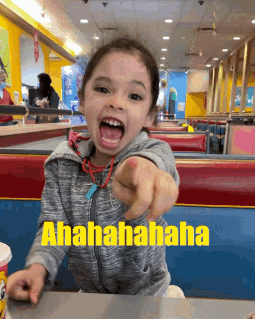 a little girl pointing at the camera with the words ahahahaha written below her