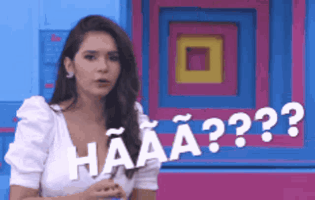 a woman is standing in front of a colorful wall and says haaaa
