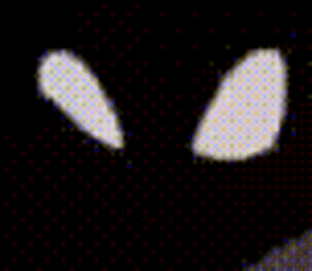 a close up of a person 's face with glowing eyes and teeth .