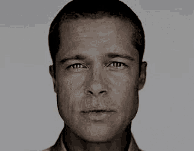 a man 's face is shown in a black and white photo .