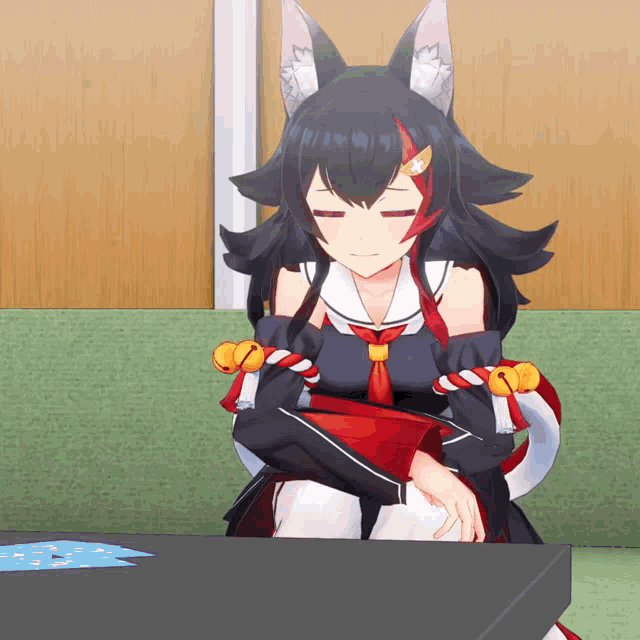a girl with a fox ear is sitting on a table with her eyes closed