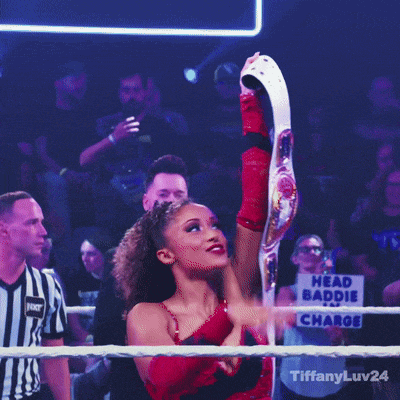 a woman in a wrestling ring with a belt that says ' tiffanyluv24 ' on it