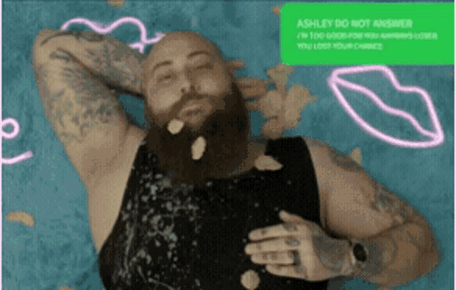 a bald man with a beard is laying on a bed with chips falling on him