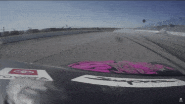 a toyota supra is driving down a track