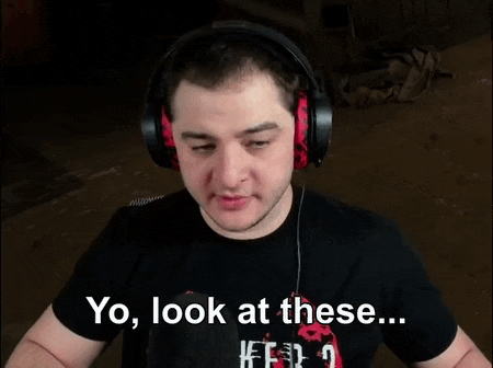 a man wearing headphones and a black shirt says " yo look at these "