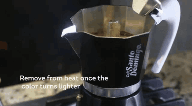 a santos domingo coffee pot is sitting on a stove top