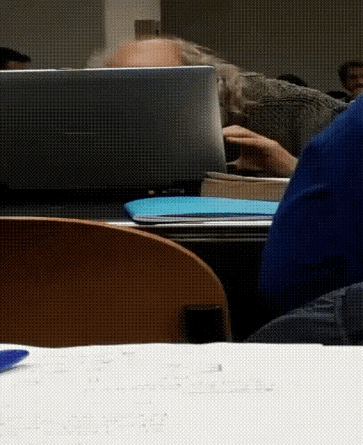 a man sits at a desk with a laptop on it
