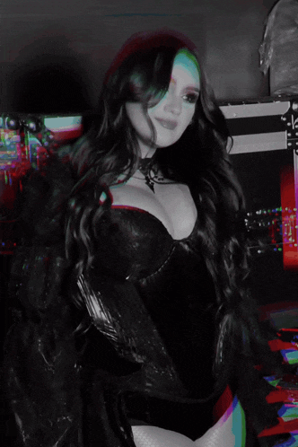 a woman in a black leather jacket is dancing