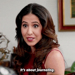 a woman says it 's about journaling in a red top