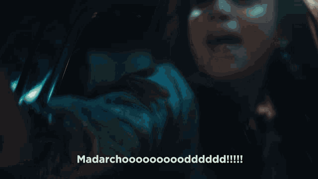 a close up of a woman screaming with the words madarchoo written in white