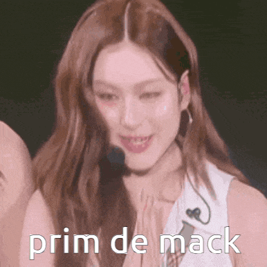 a woman with long hair is smiling with the words prim de mack above her