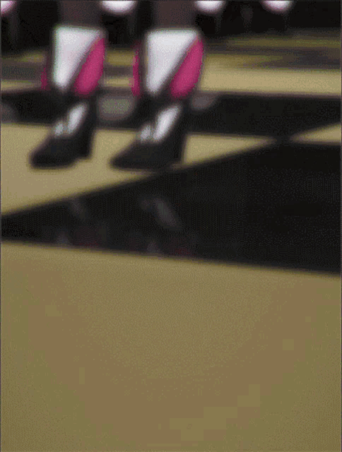 a blurry picture of a person 's feet with pink and white shoes