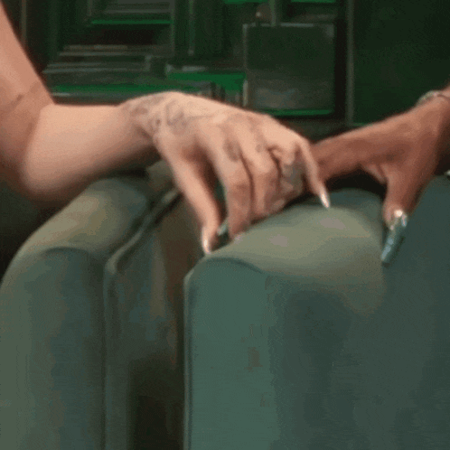 a close up of a woman 's hands on a green suitcase