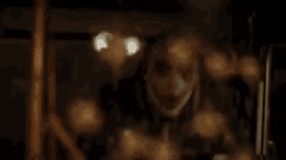 a close up of a clown 's face behind a glass door .