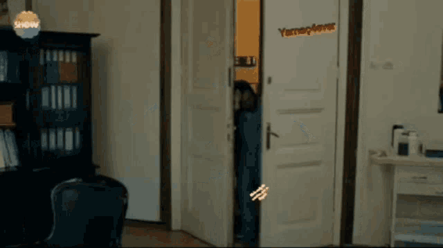 a man is standing in a doorway with the word show on the corner