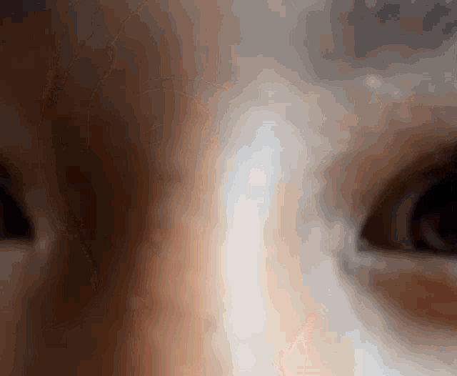a close up of a person 's eyes with a white stripe between them