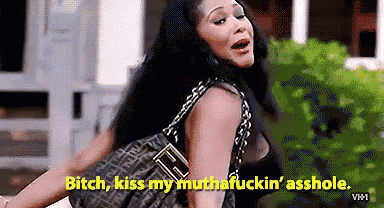 a woman is holding a purse and says `` bitch , kiss my muthafuckin ' asshole '' .