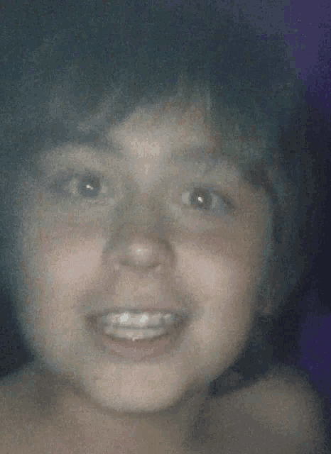 a close up of a child 's face smiling