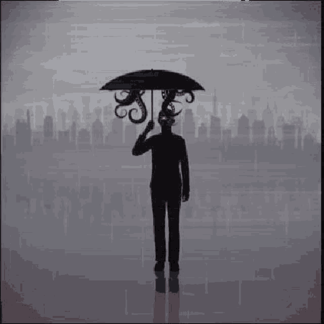 a man is standing in the rain holding an umbrella with a octopus on it .