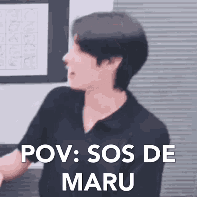 a man in a black shirt is standing in front of a wall and saying pov sos de maru .