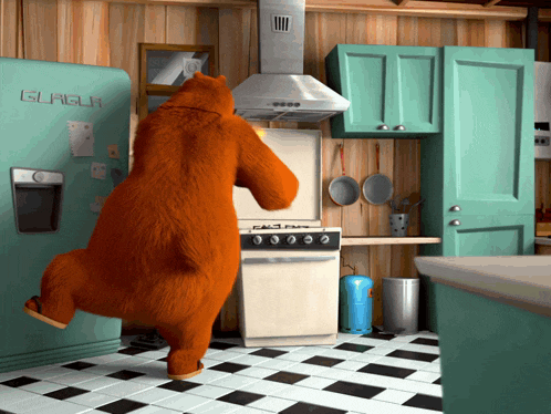 a bear in a kitchen with a glasur refrigerator behind it