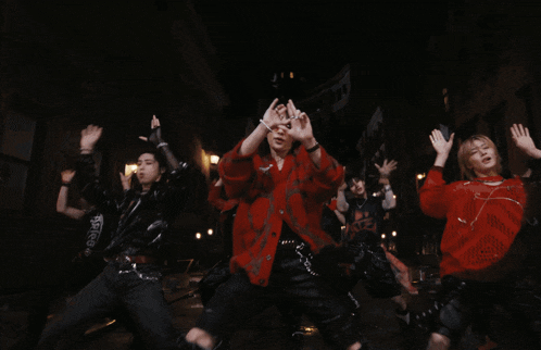 a woman wearing red sunglasses and a red jacket is dancing