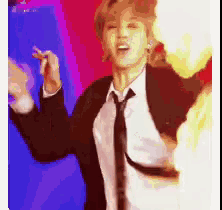 a man in a suit and tie is dancing in a room