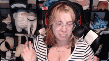 a woman wearing headphones and a striped shirt is smiling