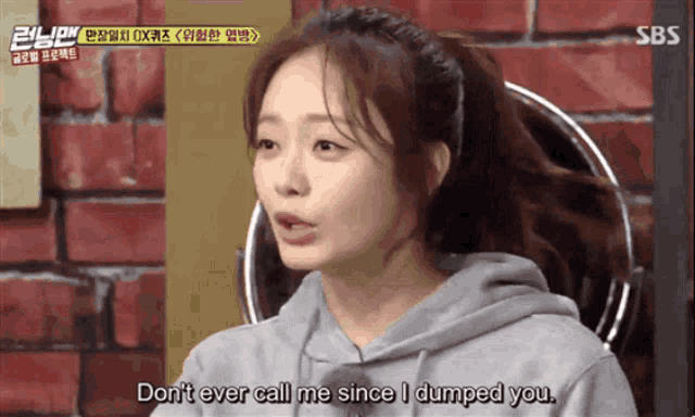 a woman sitting in front of a brick wall says " don t ever call me since i dumped you "