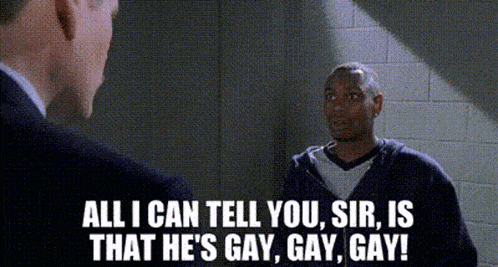 a man in a suit is talking to a man in a prison cell .
