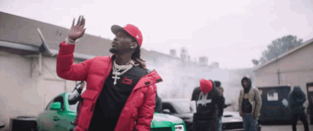 a man wearing a red jacket and a red hat with the letter r on it