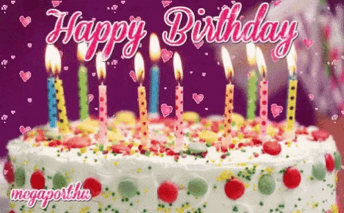 a birthday cake with candles and sprinkles and the words happy birthday written on it