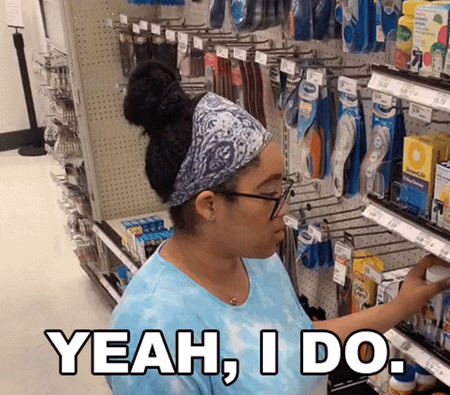 a woman in a blue shirt says yeah i do while shopping in a store