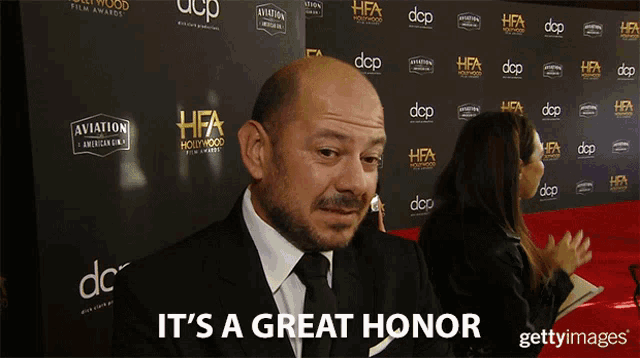 a man says it 's a great honor in front of a wall that says aviation
