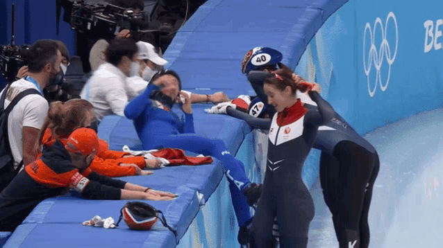 a woman wearing a number 40 helmet is talking to another woman
