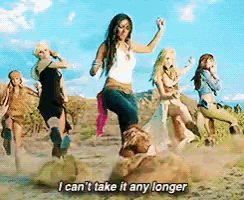 a group of women are dancing in the dirt and one of them is saying i can 't take it any longer