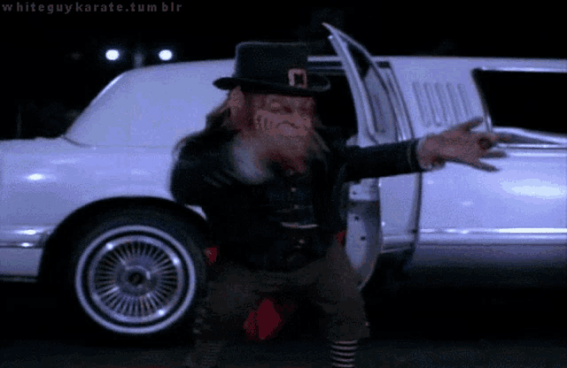 a leprechaun is standing in front of a white limousine with the caption whiteguykarate.tumblr