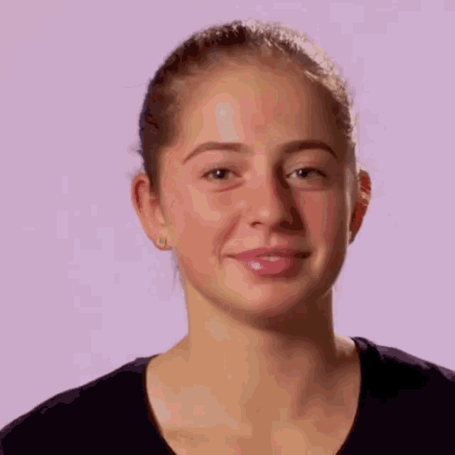 a close up of a woman 's face on a pink background