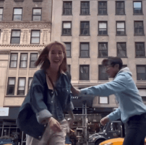 a man and a woman are dancing in front of a building that says tery