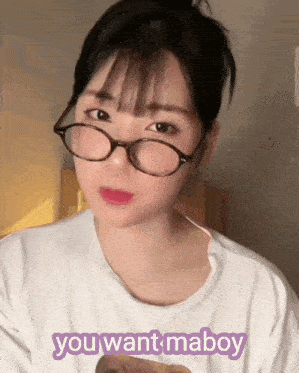 a girl wearing glasses and a white shirt that says you want maboy