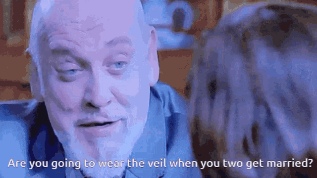 a man with a beard is talking to a woman and the words are you going to wear the veil